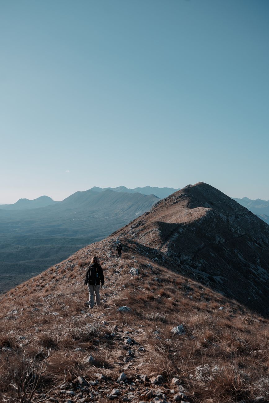 Solitary explorer along mountain ridge